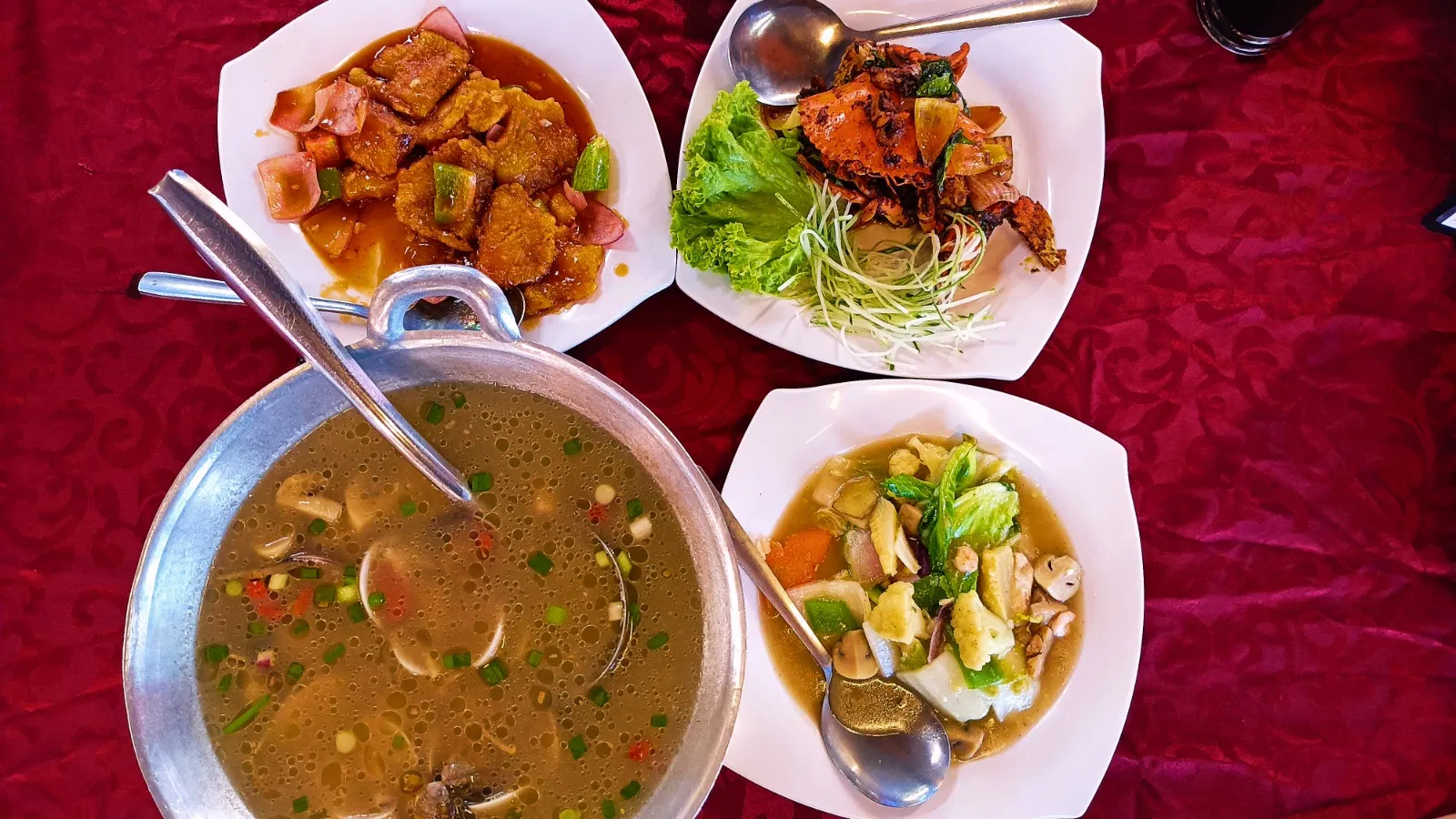 Chilli crab, fried fish and tom yam shared at a Pasir Penambang seafood table
